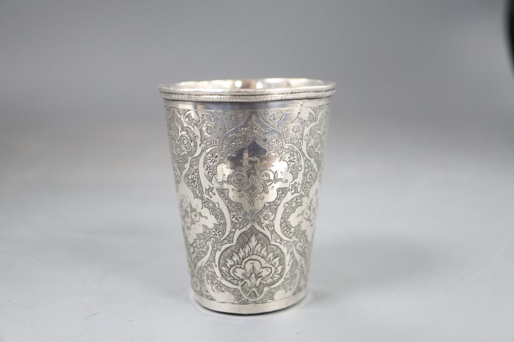 A Persian engraved white metal beaker, 71mm, 100 grams.